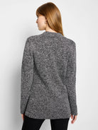 Black and white speckled knit blazer with a collar and long sleeves, shown from behind.