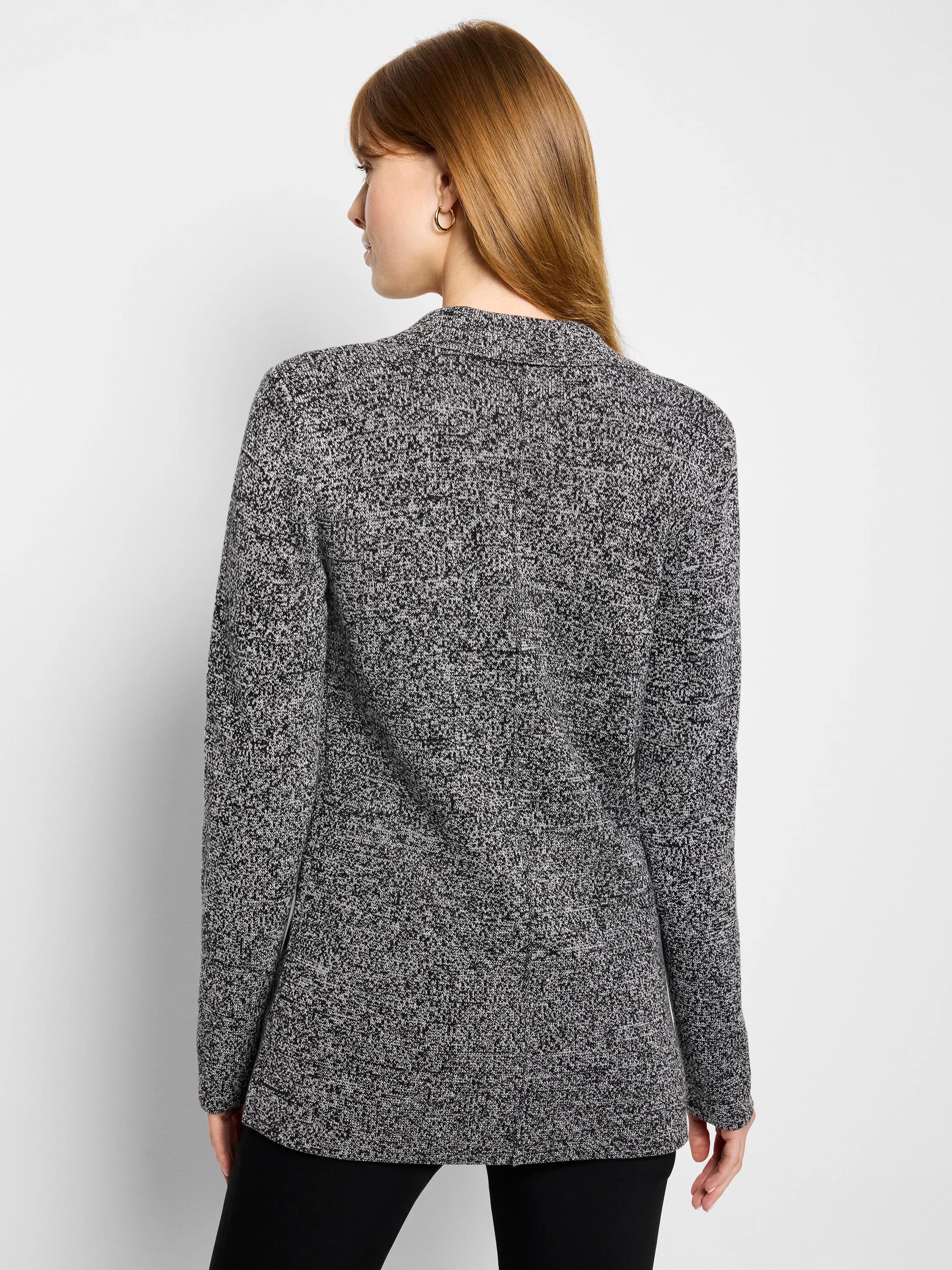 Black and white speckled knit blazer with a collar and long sleeves, shown from behind.
