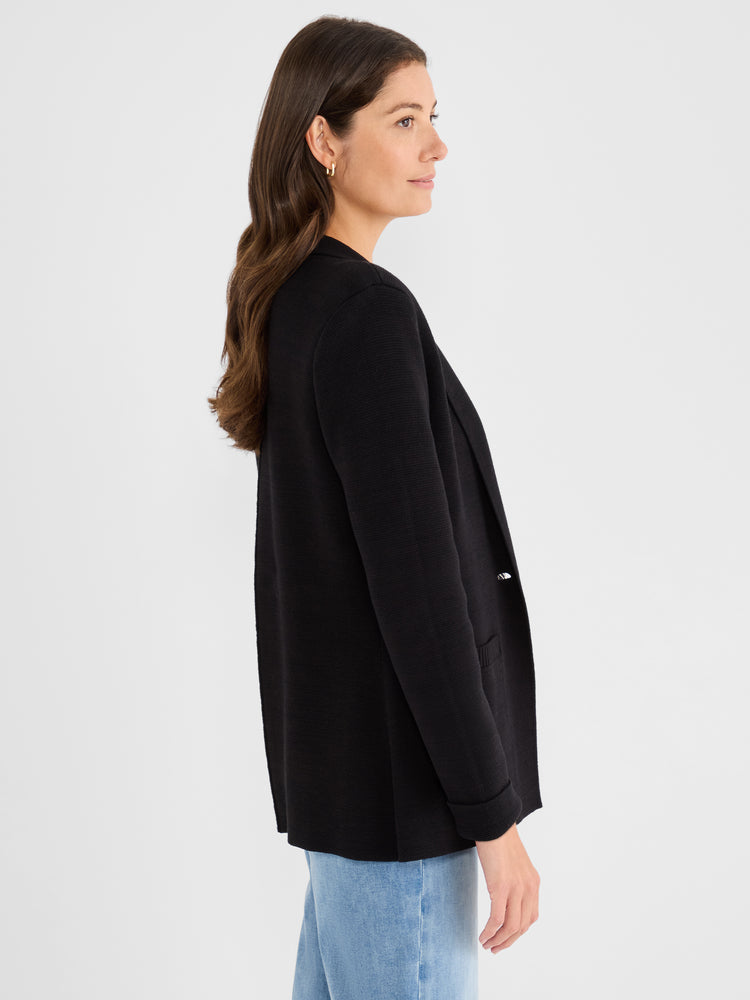 This black relaxed-fit knit blazer features a textured waffle weave, an open front, and cuffed sleeves.