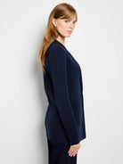 Navy knit blazer, tailored, with a single button closure and front patch pockets.