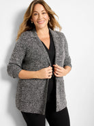 Marled black and white knit blazer with speckled texture, lapel collar, and open front.