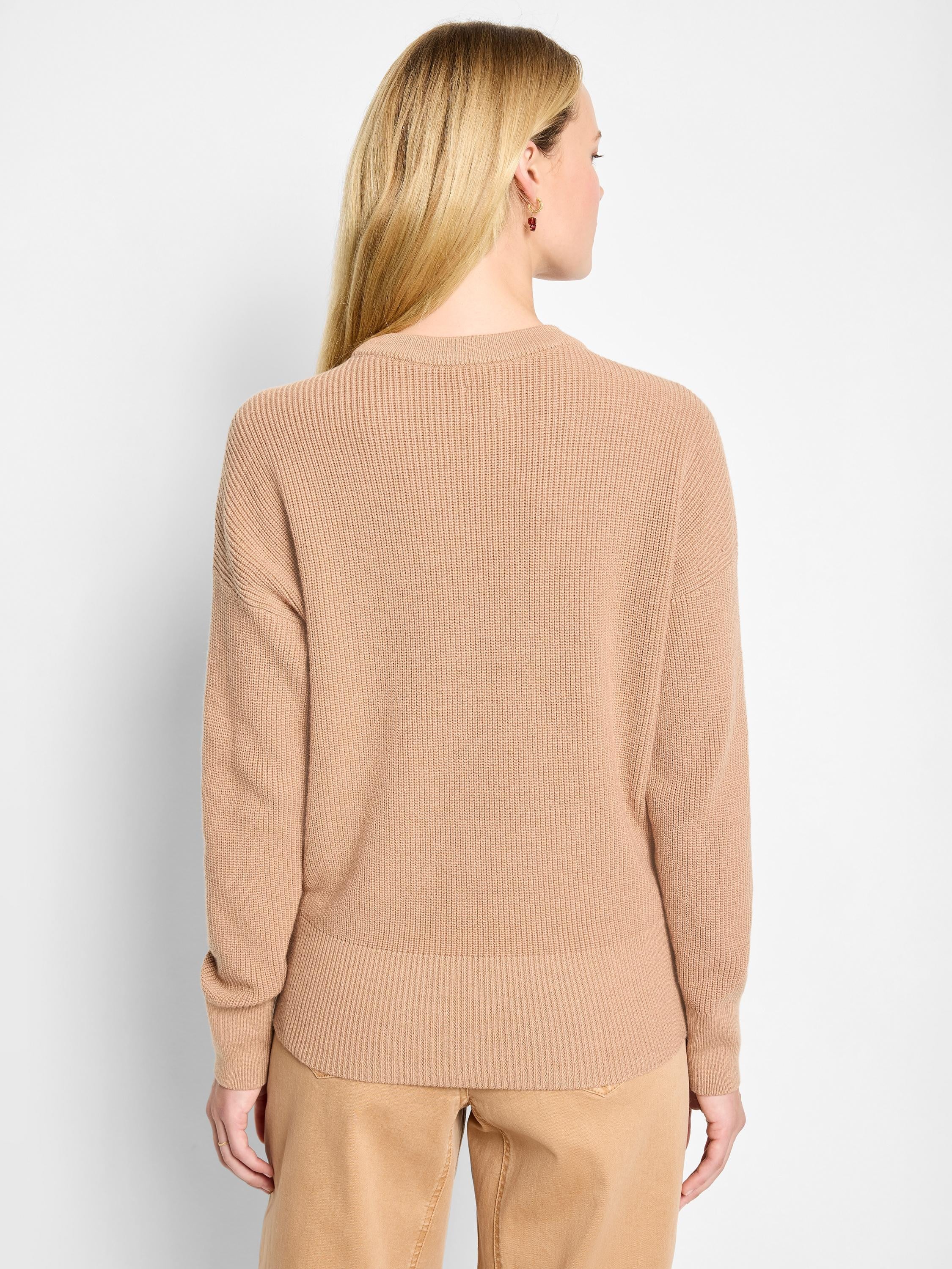 Tan shaker stitch crew neck sweater. Ribbed knit, relaxed fit, long sleeves, shown on model from the back.