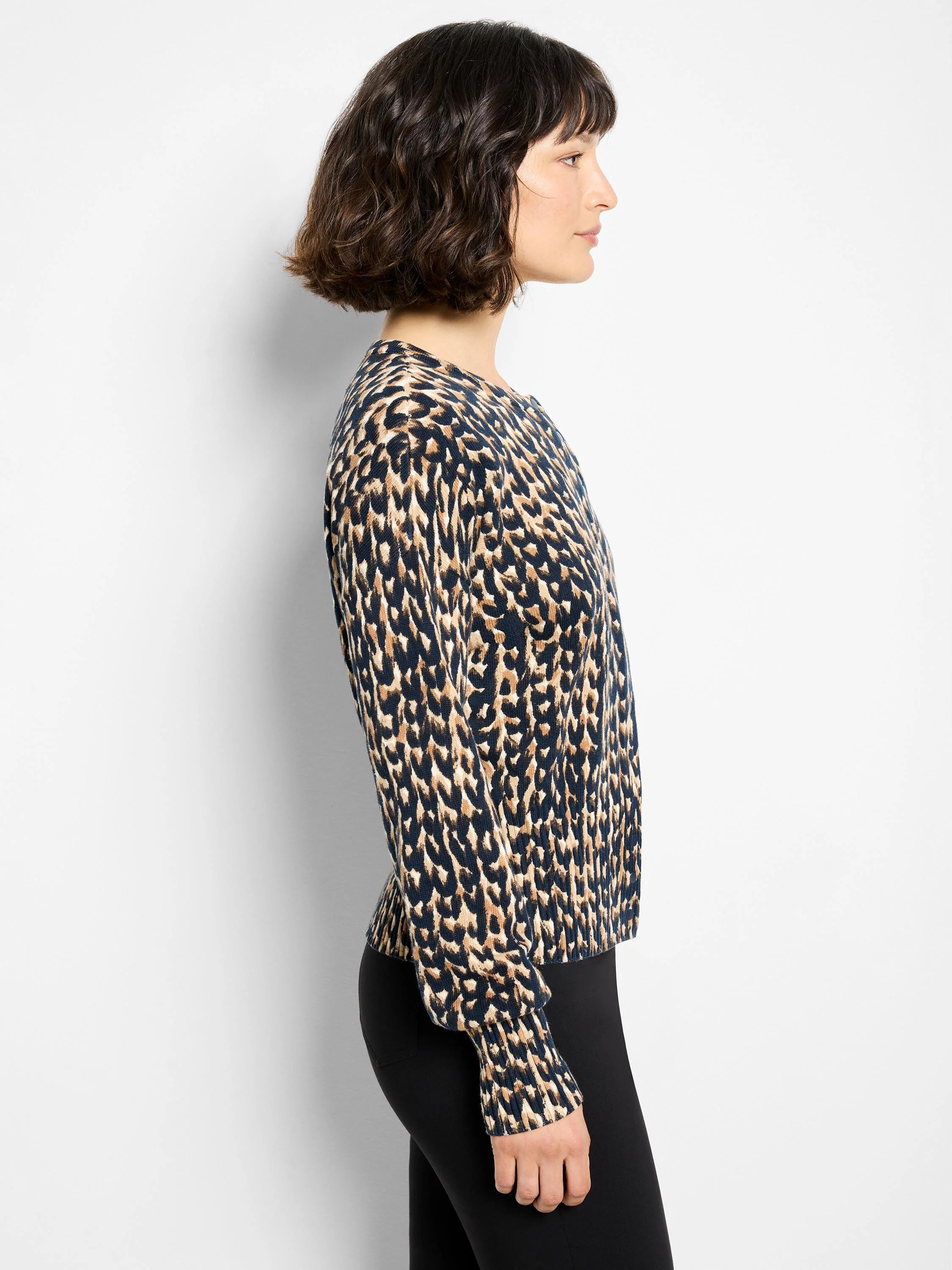 Navy, tan, and black long-sleeved cardigan with leopard print, shown worn in profile.