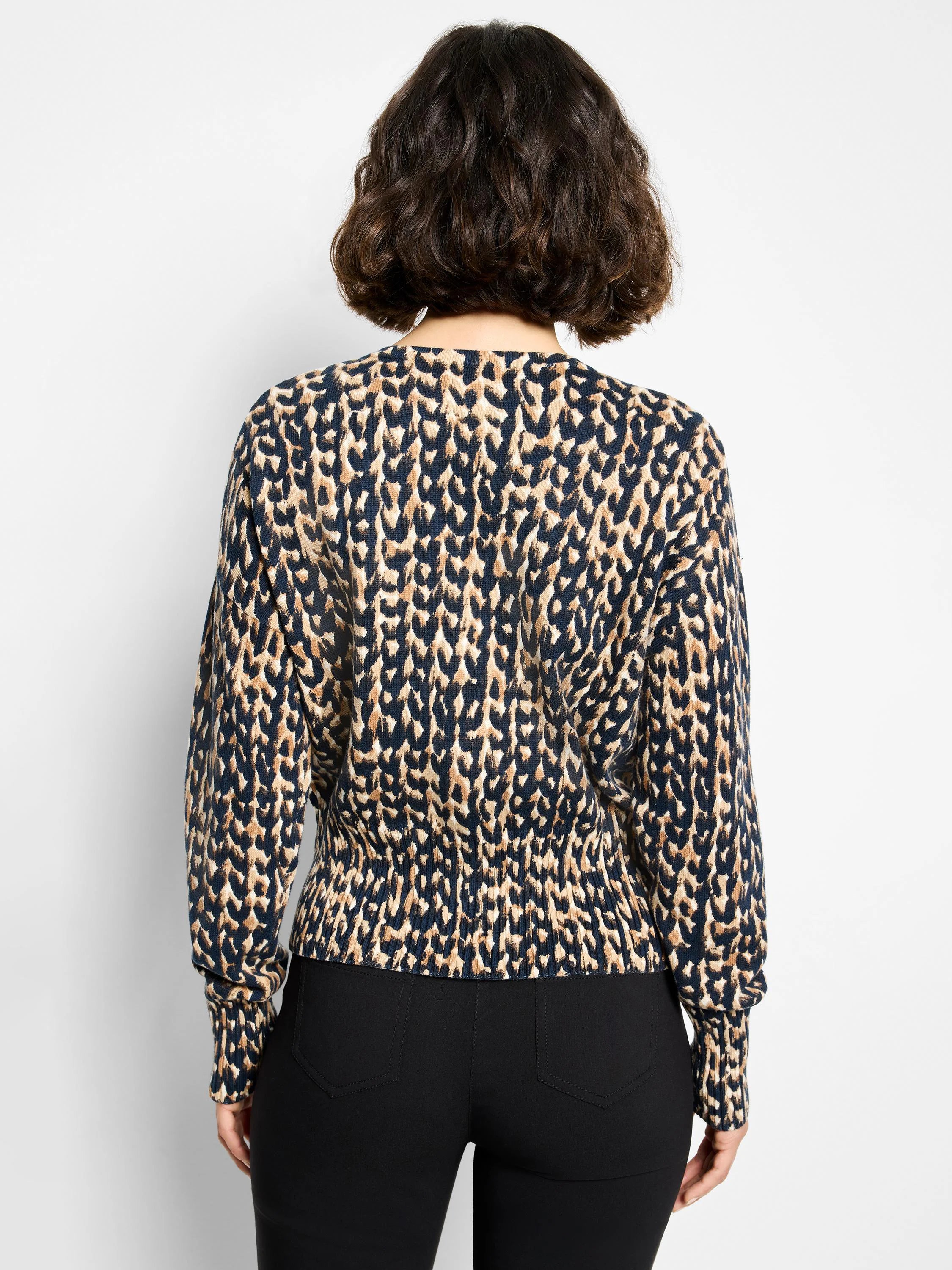 Back of cardigan: navy and tan stitch print, long sleeves, gathered elasticated hem.