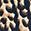 Dappled pattern of irregular dark brown & black splotches on a light beige background.