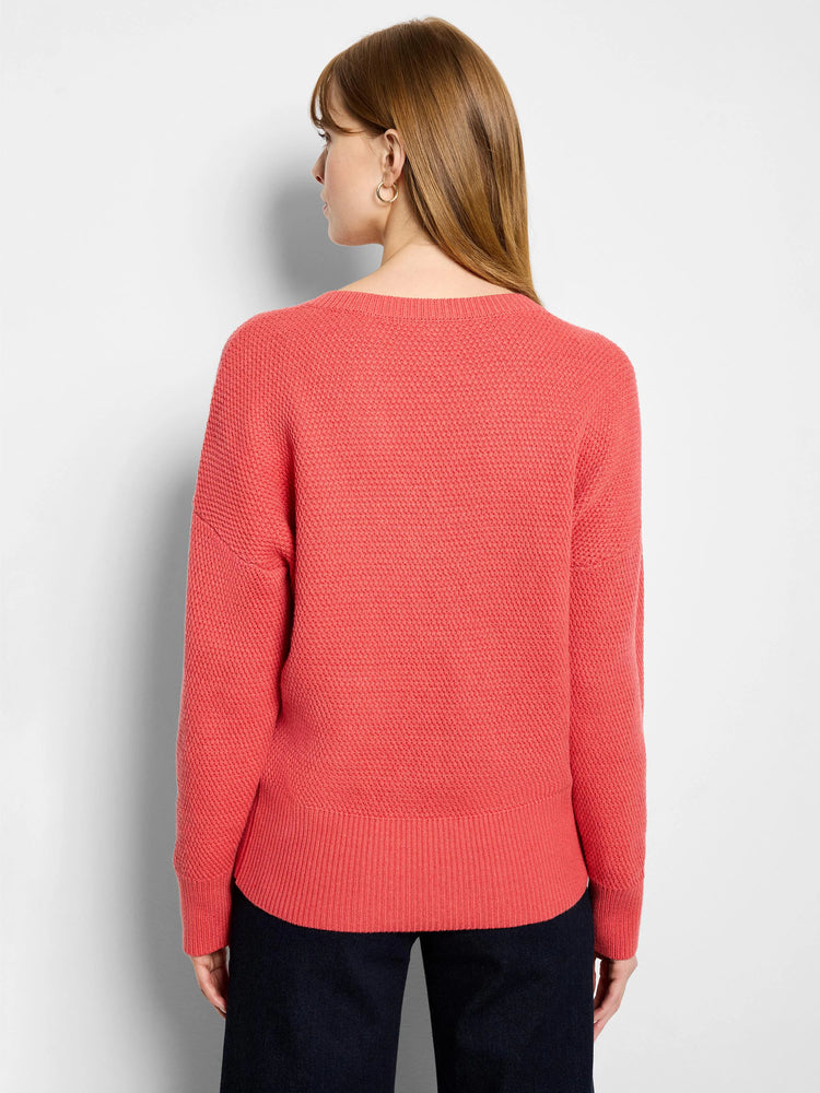 Coral tuck stitch sweater, back view. Features textured knit, ribbed hem/cuffs, rounded back neckline.