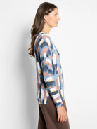 Brushstrokes Waffle V-Neck Sweater with abstract multicolor pattern: navy, light blue, pink, cream, yellow.