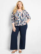 V-neck sweater with abstract blue, brown, yellow, and cream pattern. Features ribbed cuffs & hem.