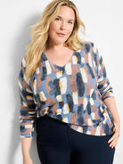 Waffle V-neck sweater with blue, rose, cream, & yellow abstract brushstroke pattern.