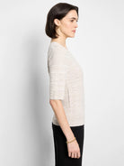 Light beige sweater tee with elbow-length sleeves and a horizontal textured knit pattern.