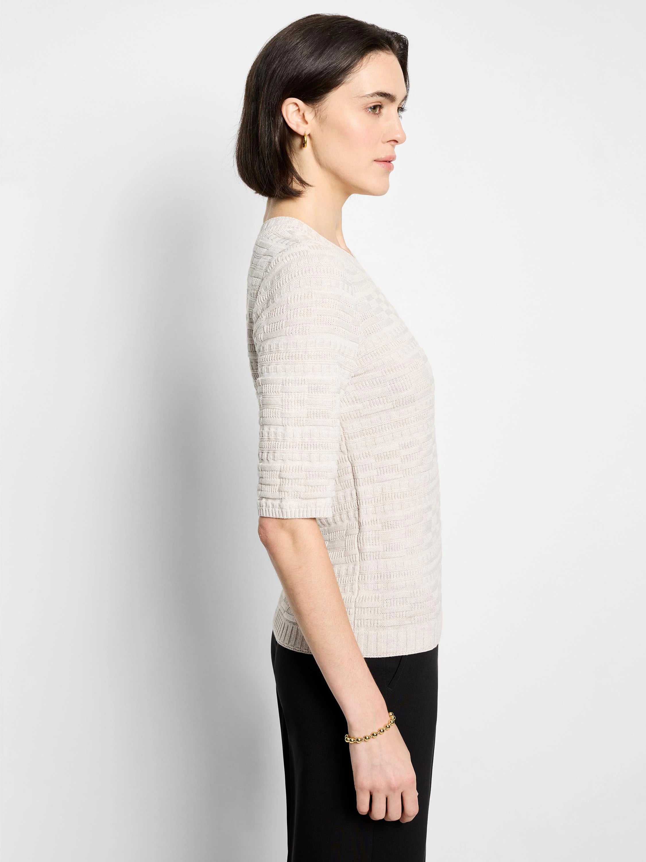 Light beige sweater tee with elbow-length sleeves and a horizontal textured knit pattern.