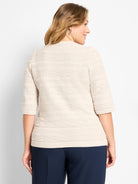 Cream textured sweater tee: geometric knit pattern, 3/4 sleeves, and ribbed hem.