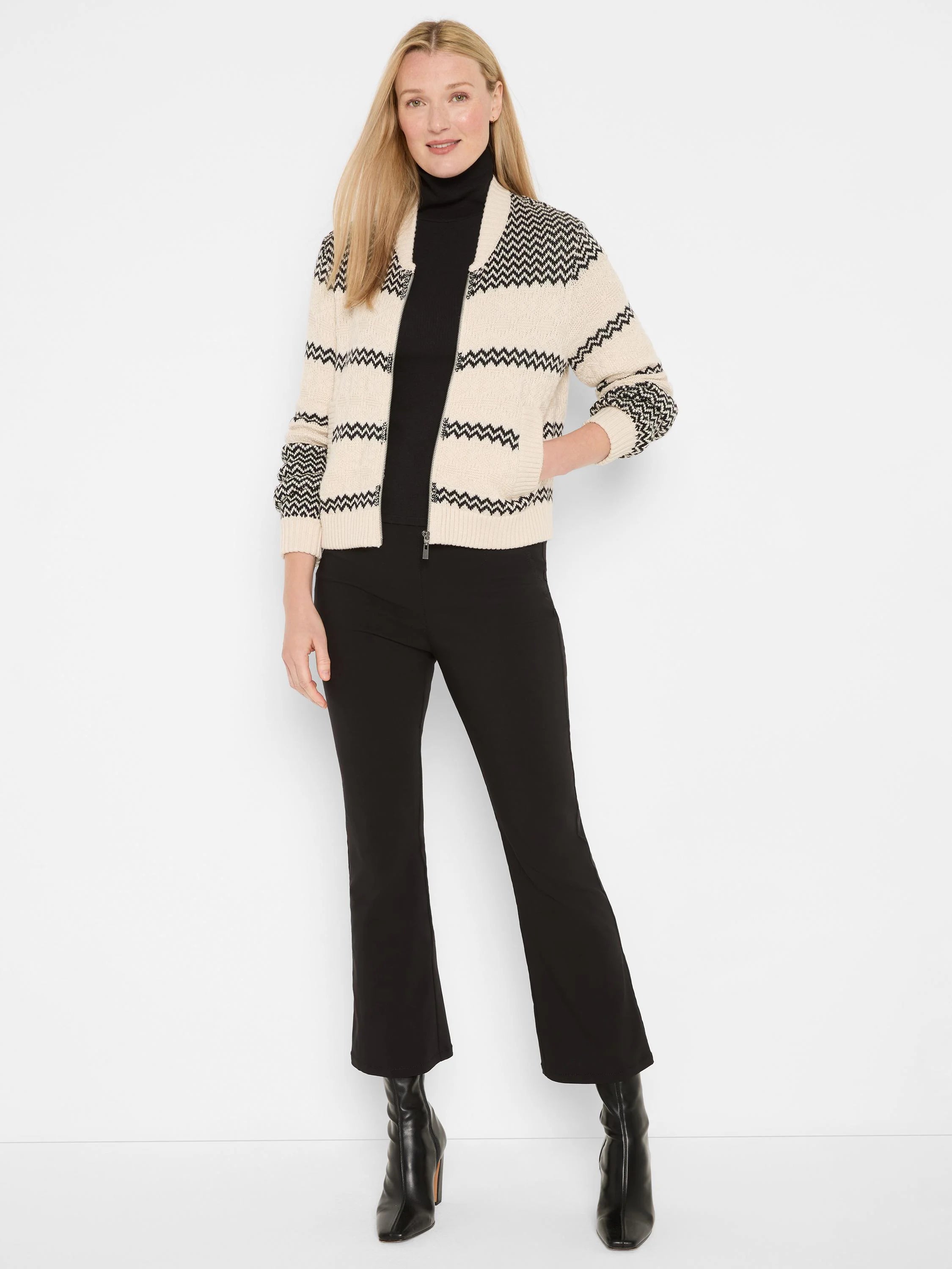 Cream bomber jacket with black zig-zag stripes, full zipper, and ribbed trim.