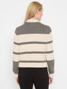 Cream and black knit bomber jacket with zig-zag pattern, seen from the back. Ribbed cuffs and hem.