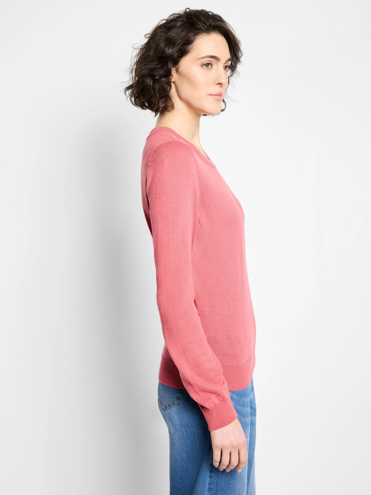Muted pink crew neck sweater with long sleeves, ribbed cuffs and hem. Relaxed fit shown on model.