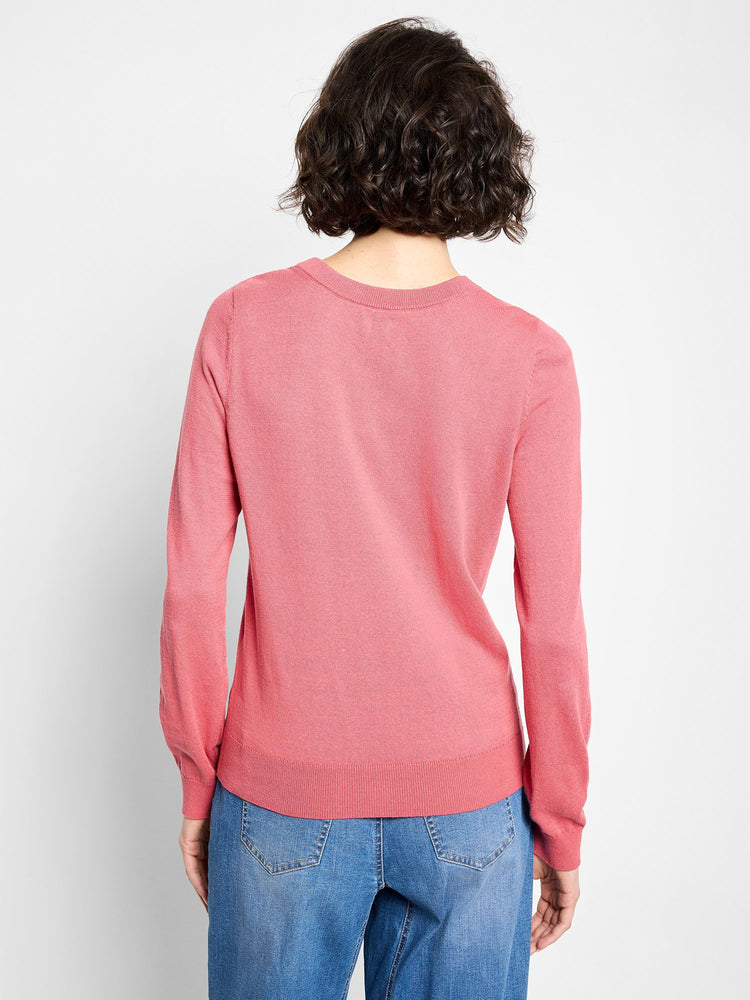 Back view of a coral pink crew neck sweater with a fine knit texture, long sleeves, ribbed cuffs, and ribbed hem.