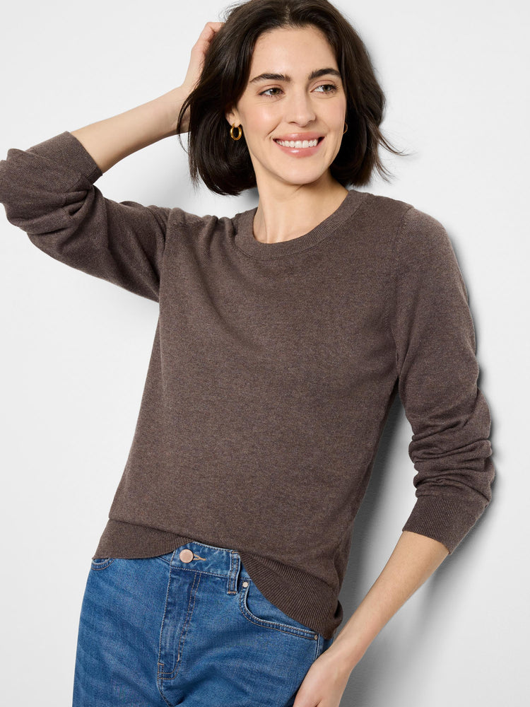 Dark brown crew neck sweater, fine knit texture with ribbed collar, cuffs, and hem. Modeled with blue jeans.