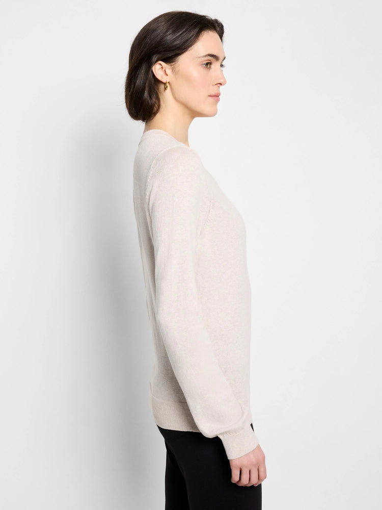 Oatmeal crew neck sweater, long sleeves with ribbed cuffs and hem, worn by a model.