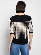 Black and light beige horizontal striped sweater tee with 3/4 sleeves and a crew neck, back view.
