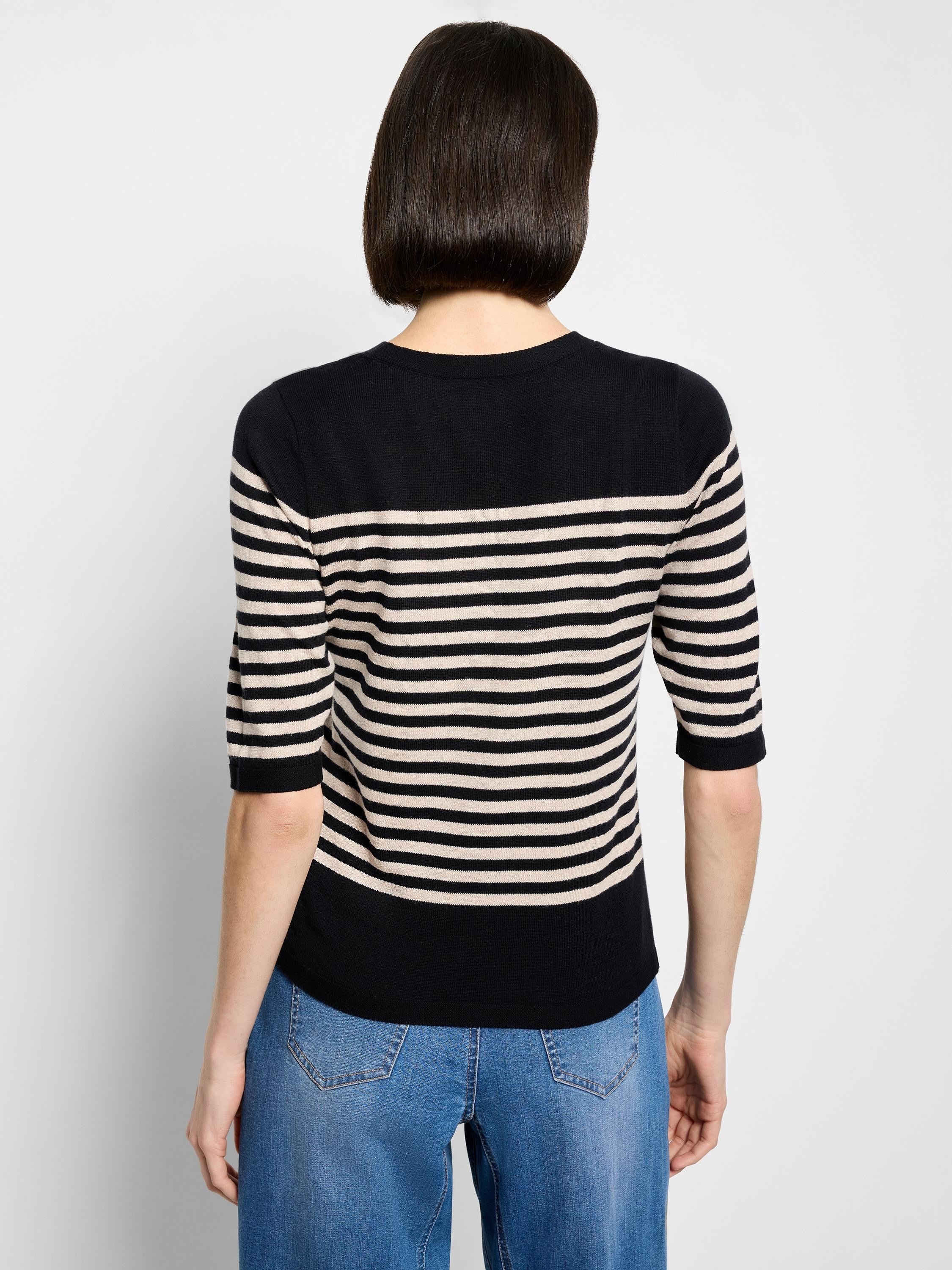 Black and light beige horizontal striped sweater tee with 3/4 sleeves and a crew neck, back view.