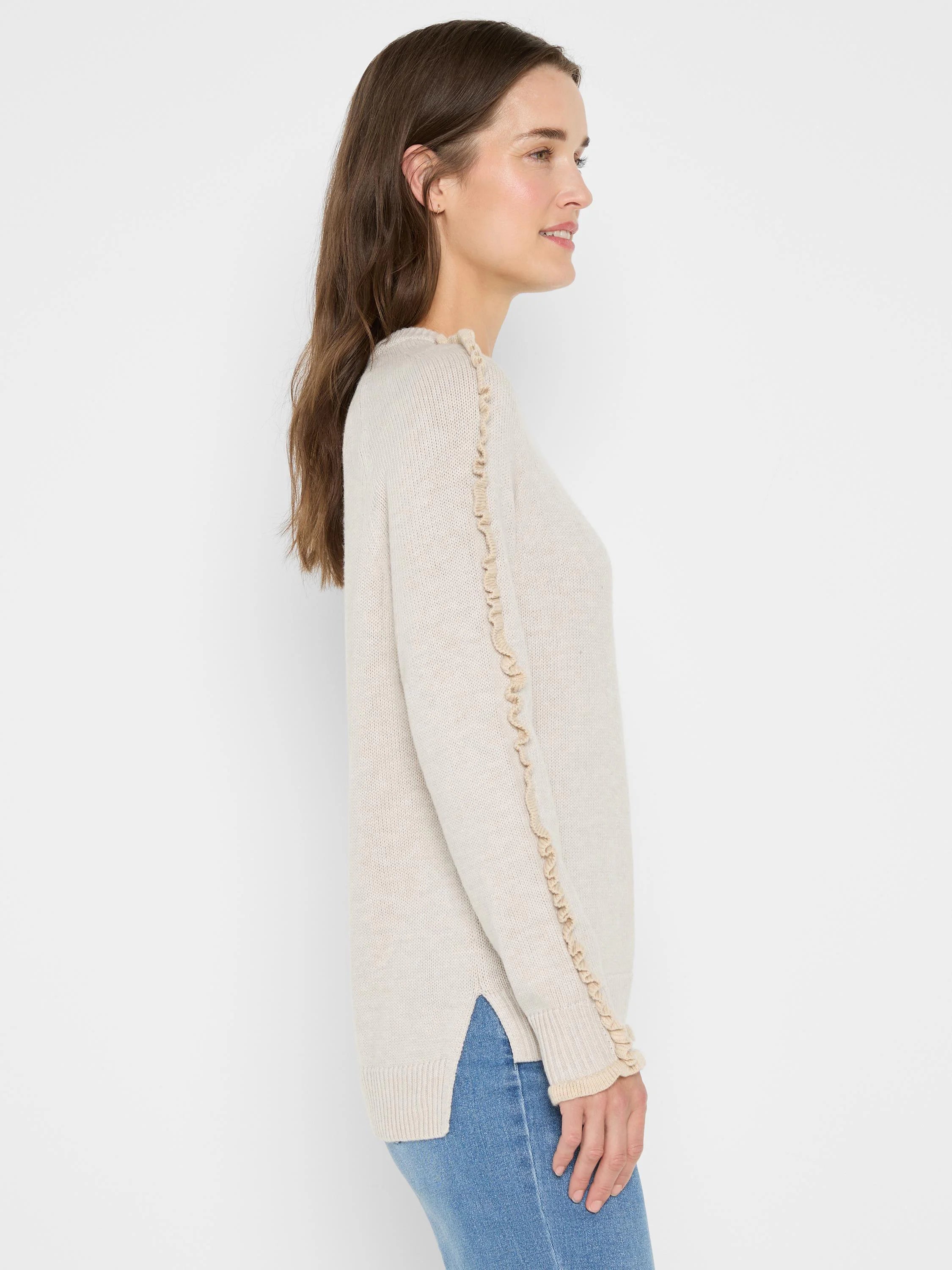 Pale beige sweater with ruffles along shoulder seams & outer sleeves. Ribbed cuffs & hem, side slits.