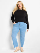 Black sweater with cream ruffles down the sleeves and at the cuffs.