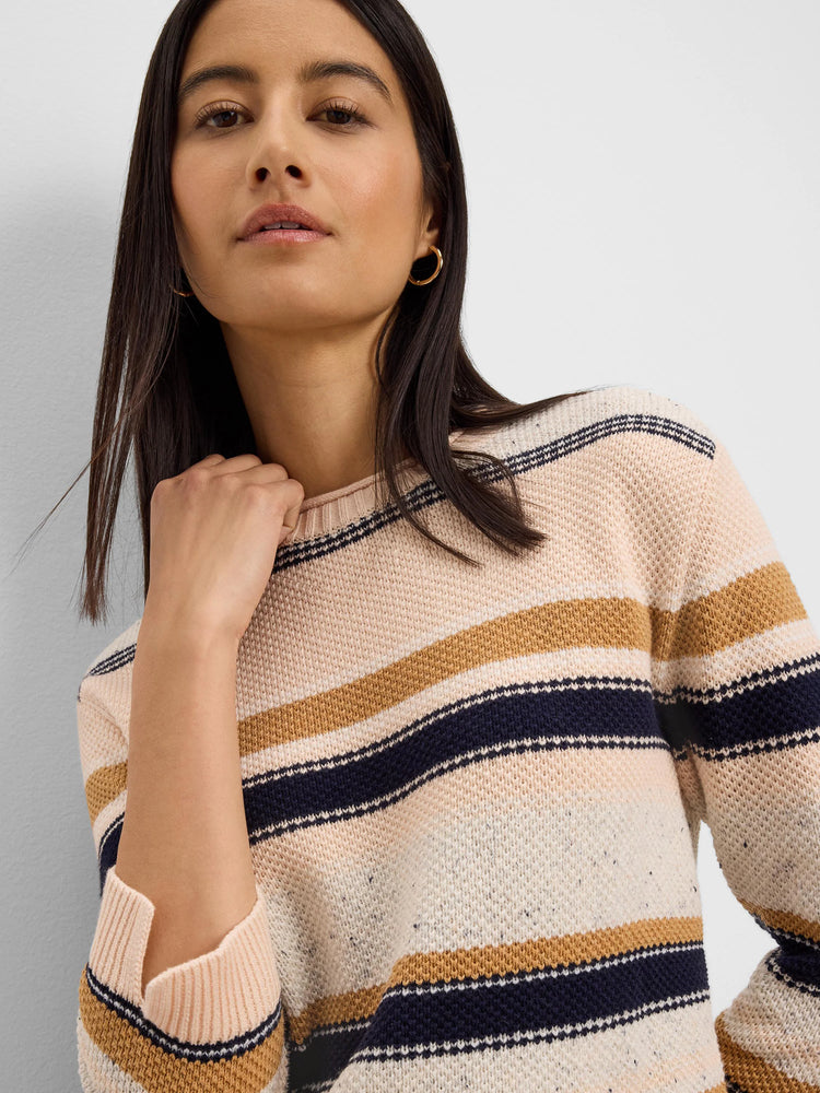 Knit sweater with horizontal stripes in cream, pale peach, navy, and mustard yellow.