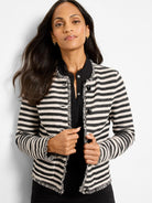 Black and off-white striped knit jacket with fringe details on all edges.