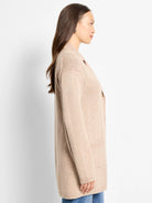 Light beige, long, open-front knit cardigan coat with subtle pink flecks.