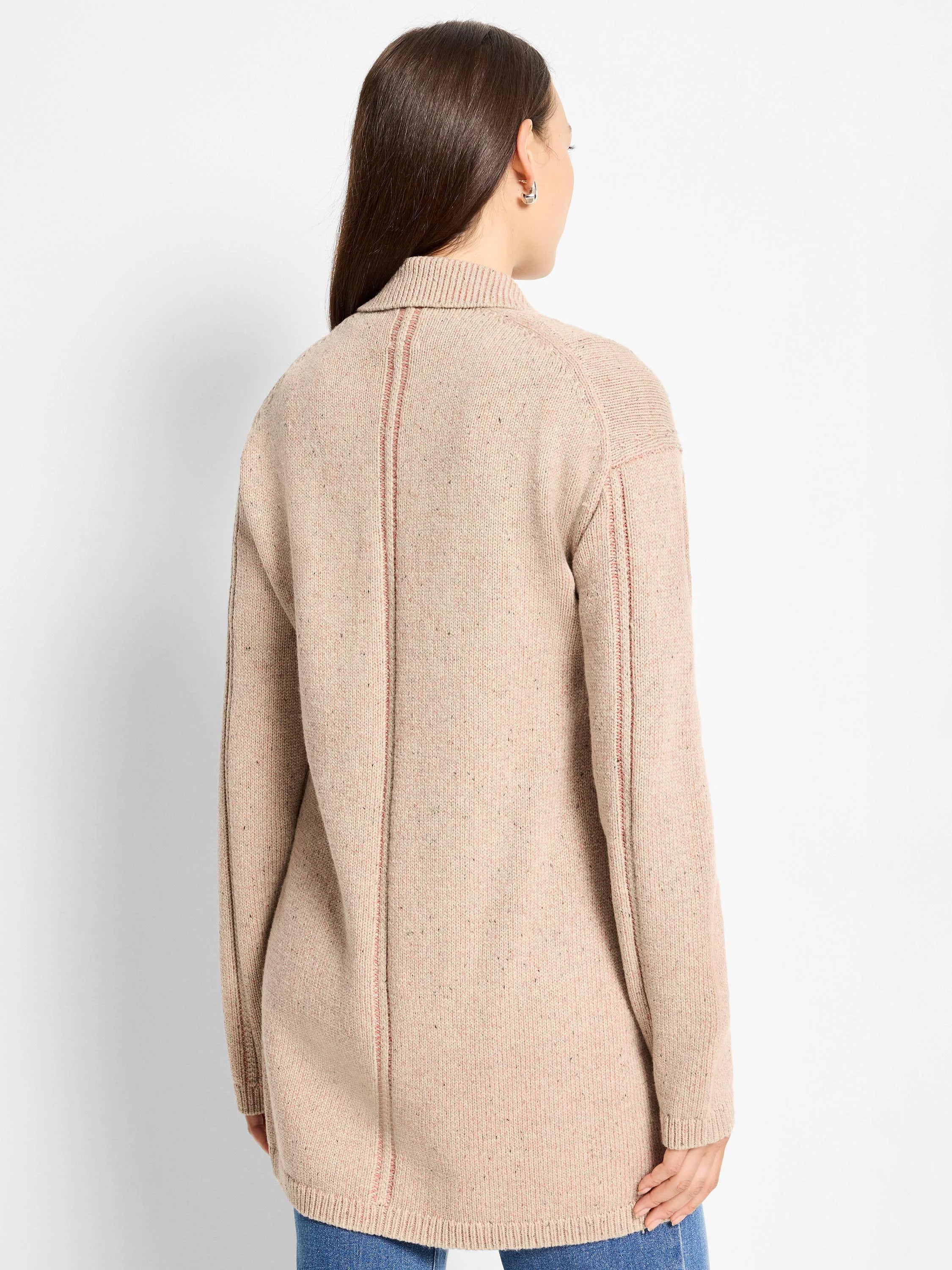 Speckled beige knit with vertical plaited details on back and sleeves. Features ribbed collar, cuffs, and hem.