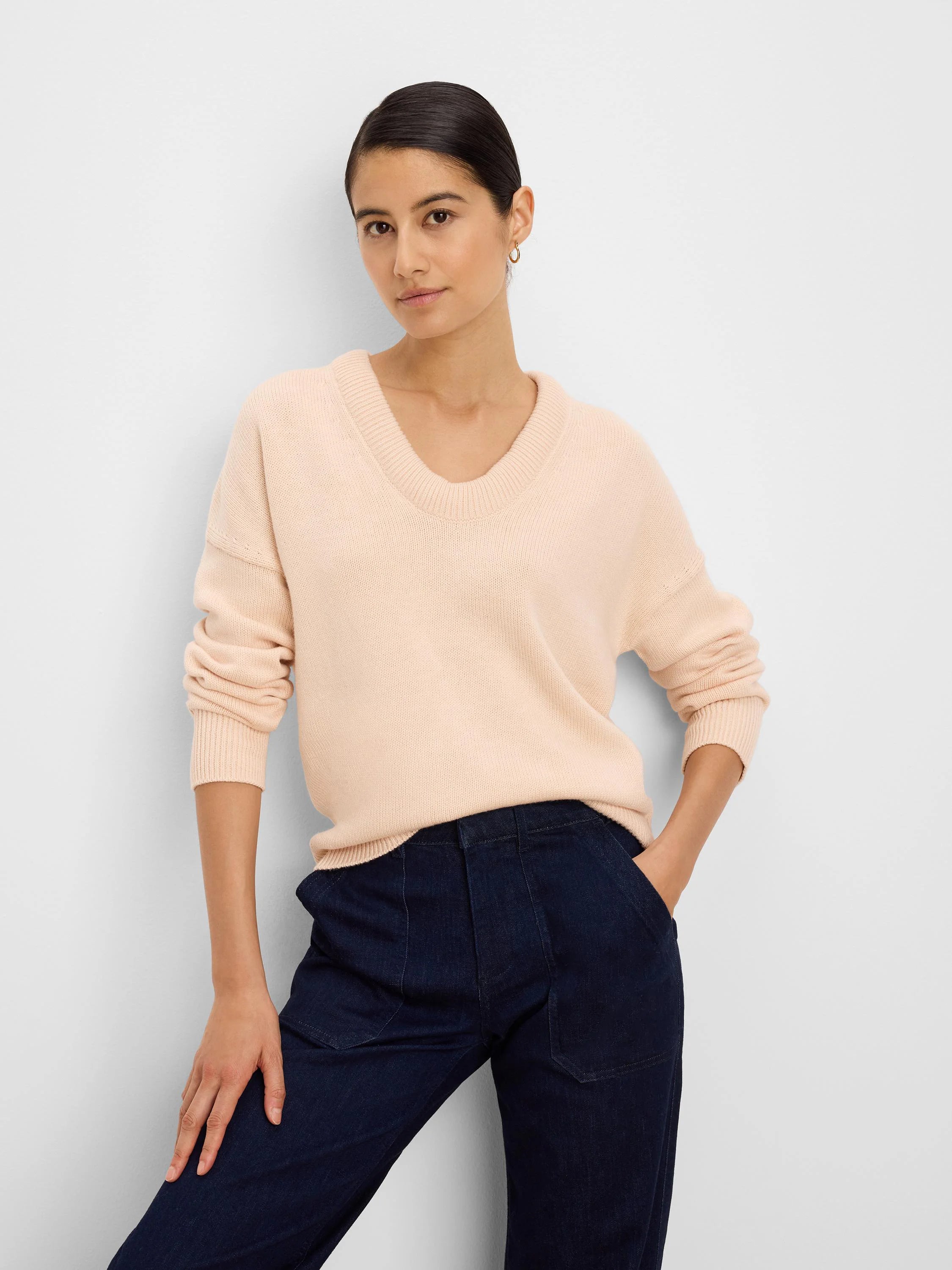 Light pinkish-beige cotton cashmere sweater with a ribbed scoop neck and cuffs.