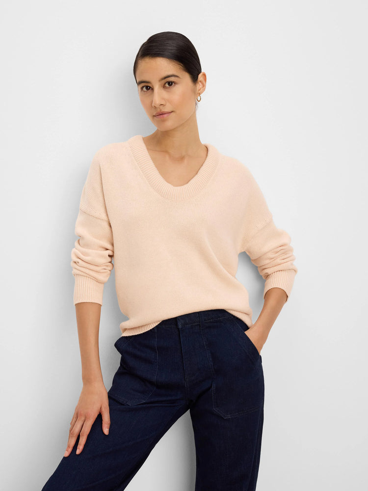 Light pinkish-beige cotton cashmere sweater with a ribbed scoop neck and cuffs.