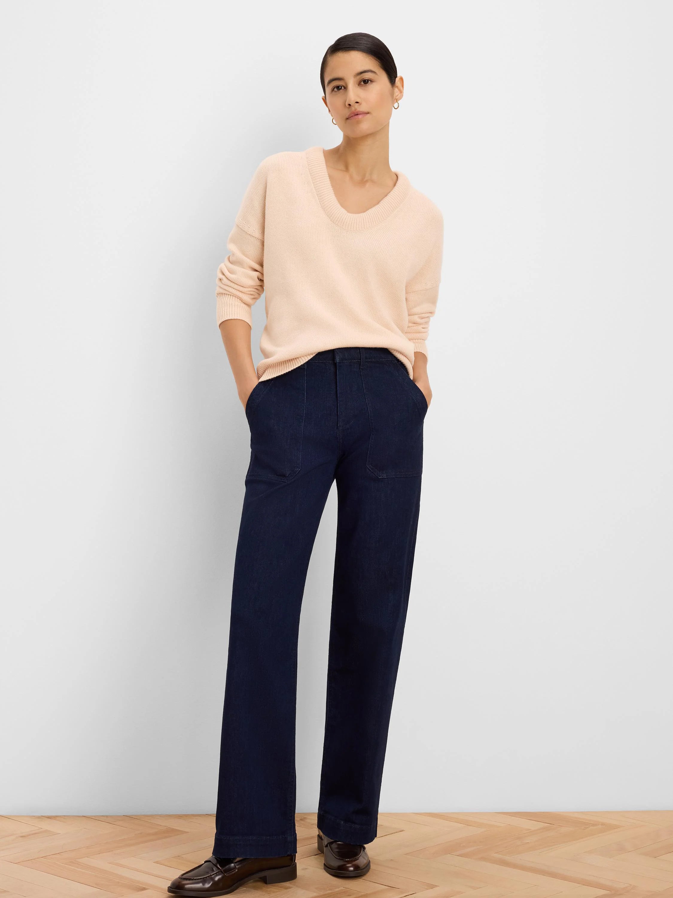 Light peach knit sweater with a relaxed fit and scoop neck.