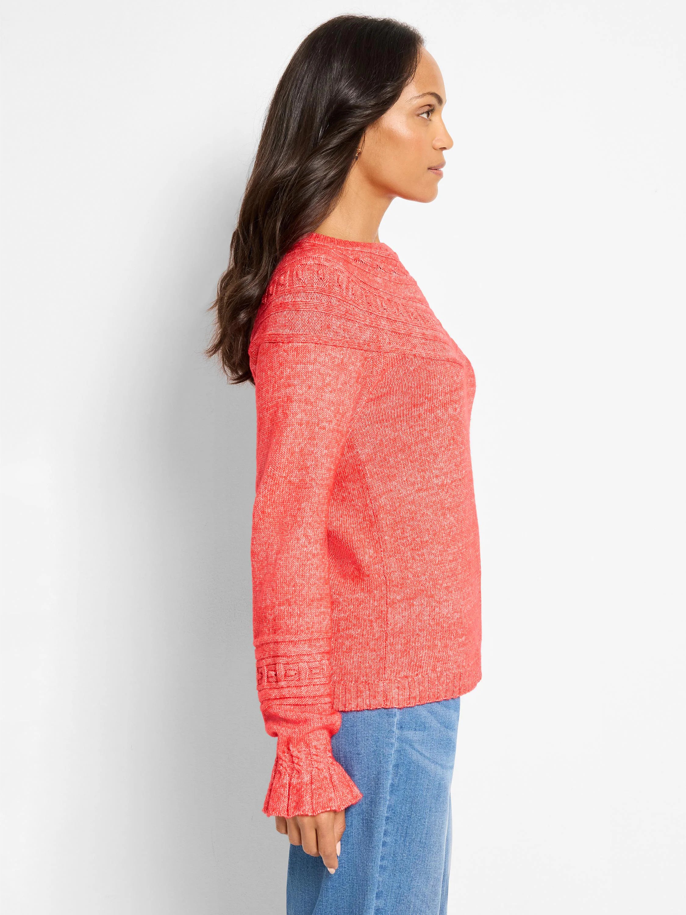 Coral melange crew neck sweater with raised dot patterns on shoulders & ruffled flared cuffs.