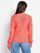 Marled coral sweater, back view. Features a round textured dot yoke and ribbed cuffs.
