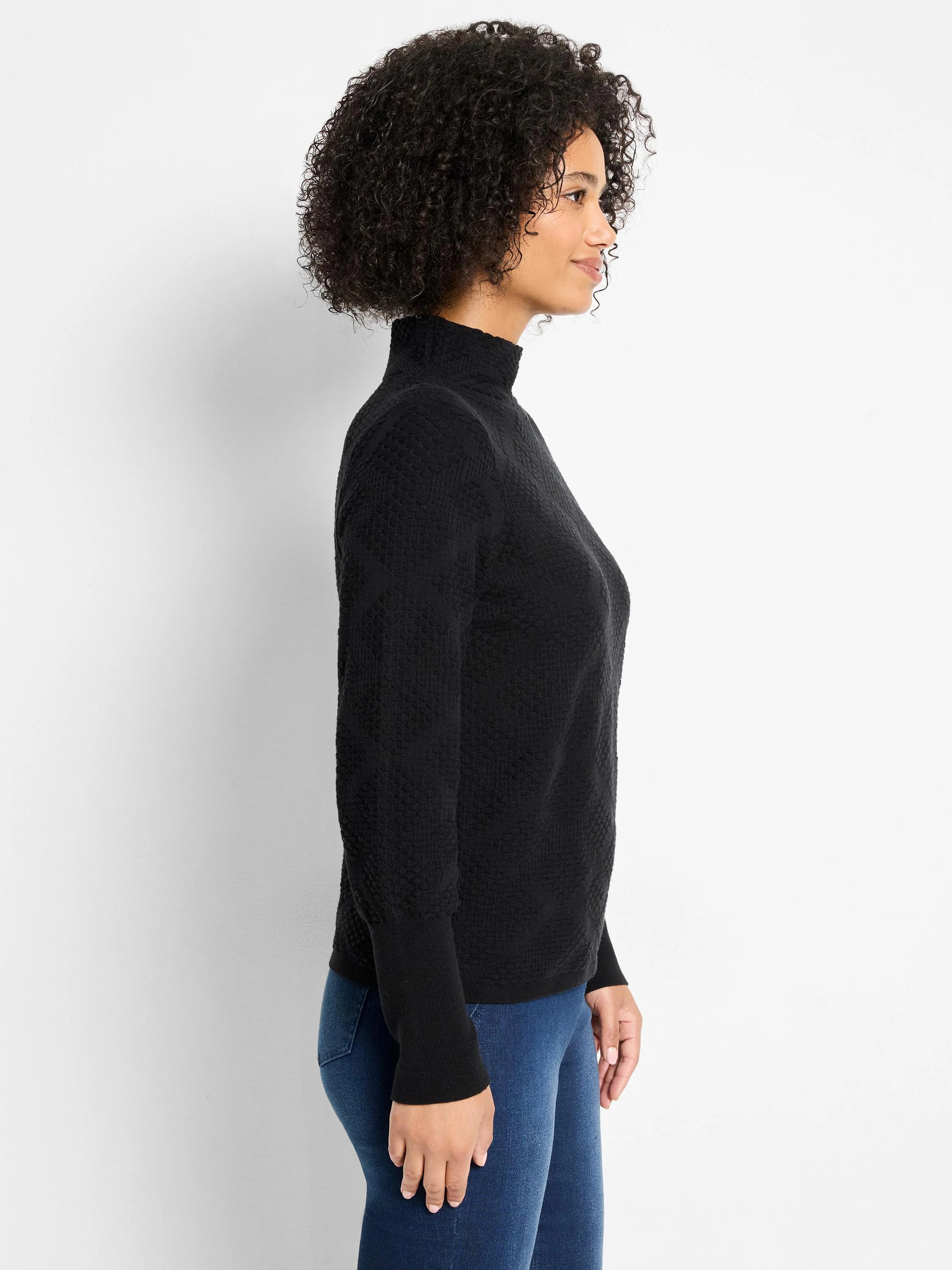Black turtleneck sweater with an all-over diamond texture pattern.