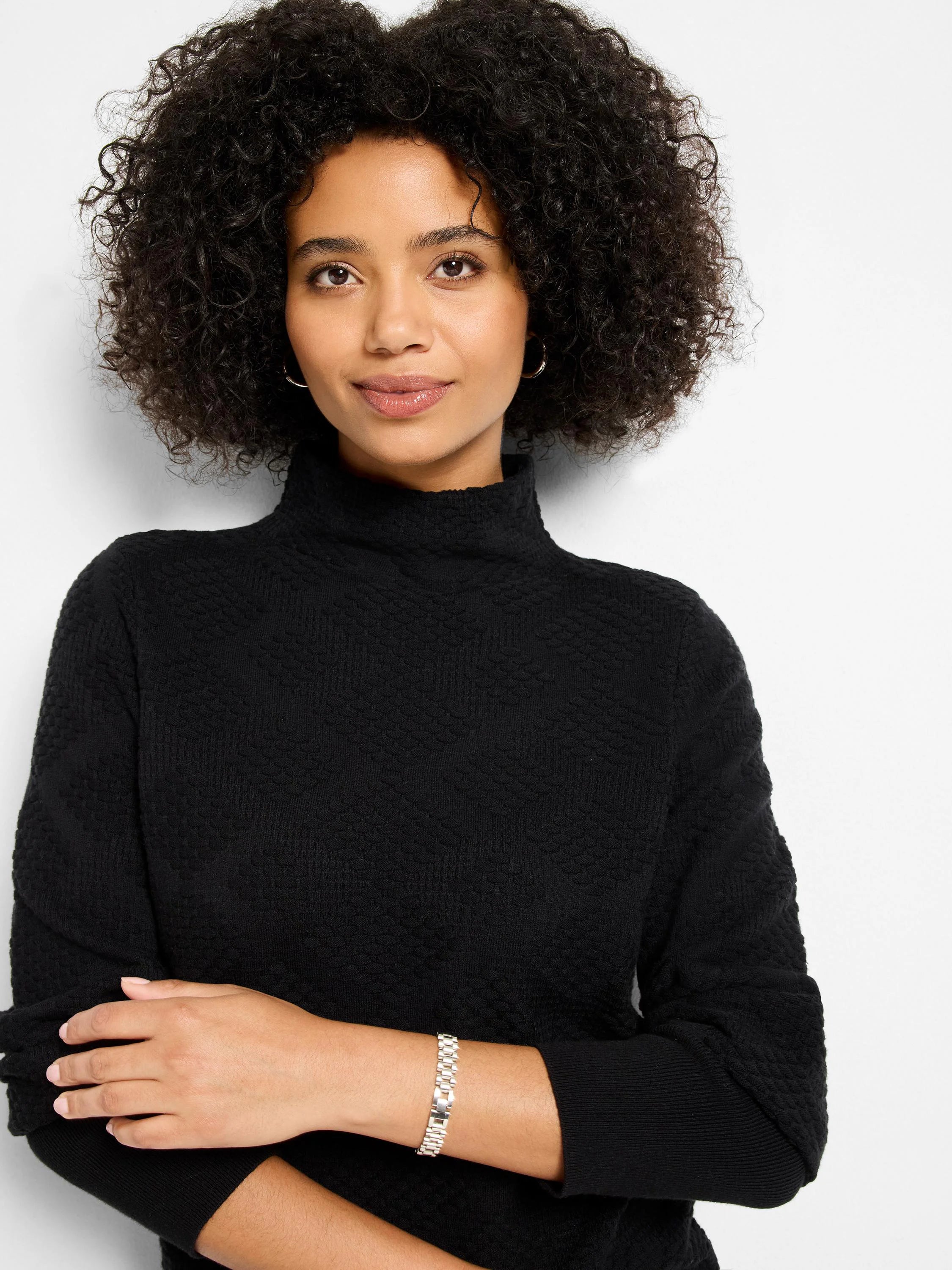 Black textured diamonds sweater with a turtleneck and ribbed cuffs.