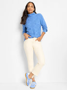 Light blue mock neck sweater with a textured diamond pattern.