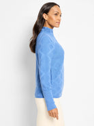 Blue mock neck sweater with an all-over raised diamond texture.