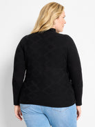 Black textured diamond sweater with mock neck and long sleeves.