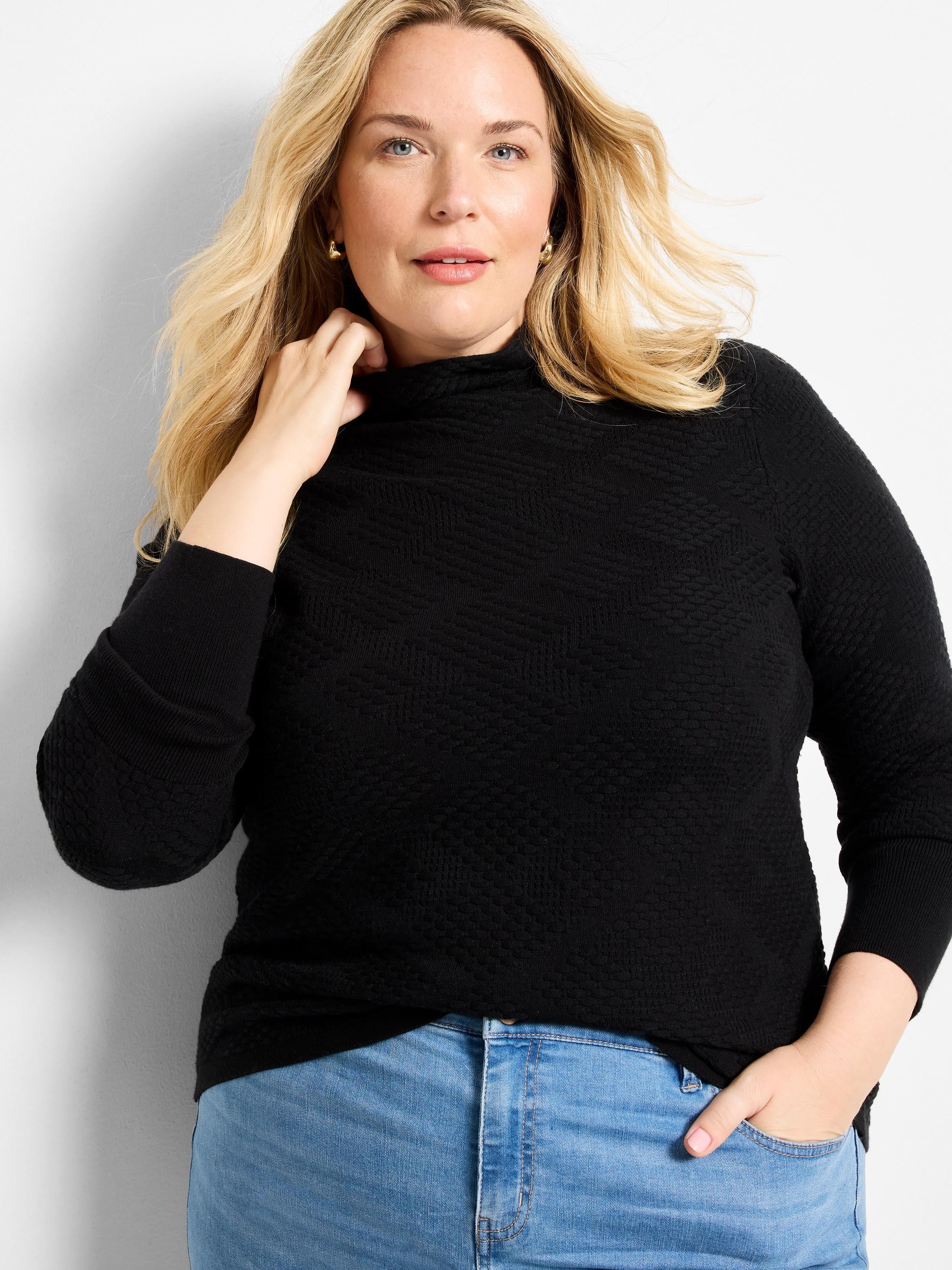 Black mock neck sweater with a subtle repeating diamond textured knit pattern.