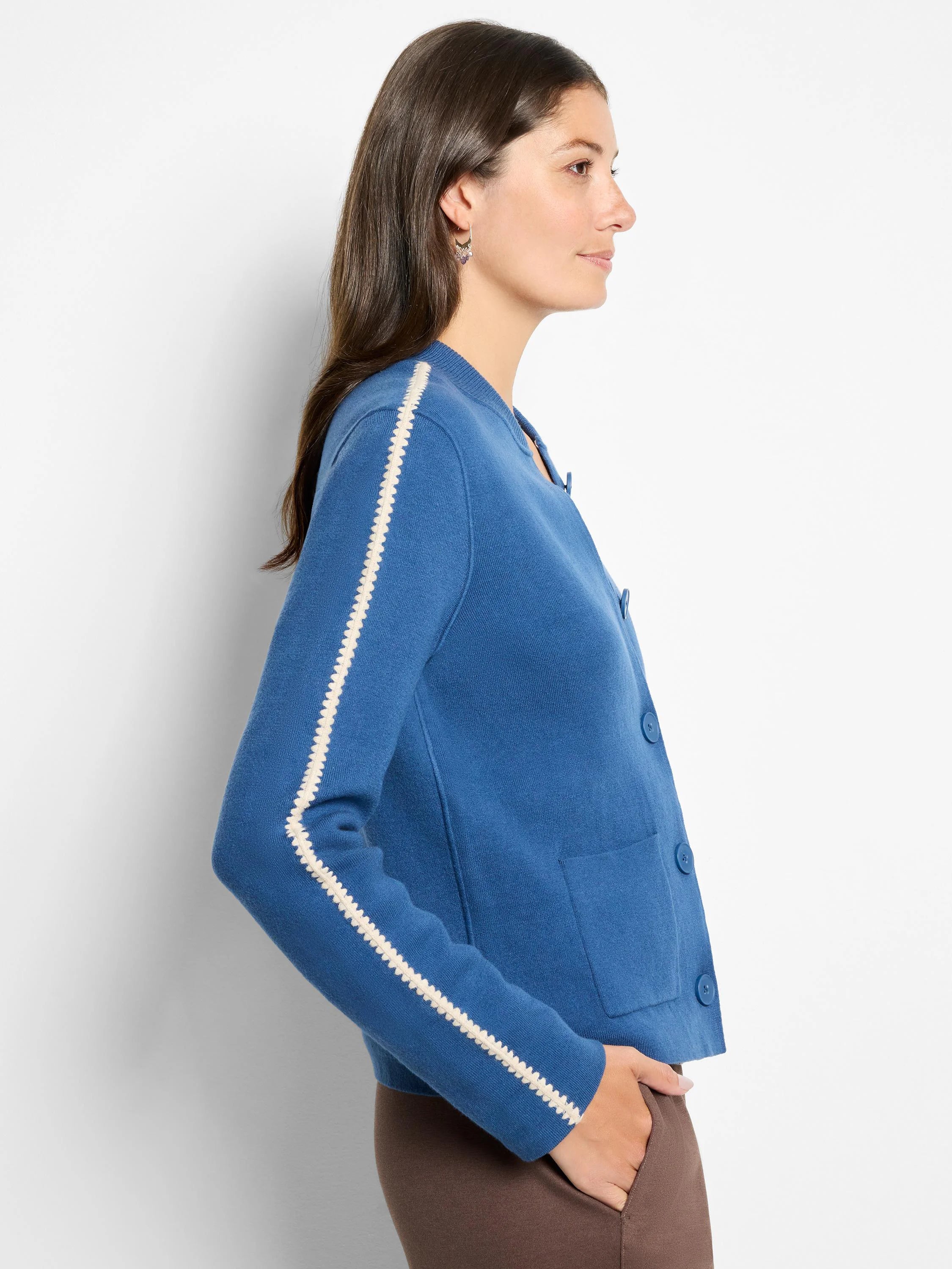 Blue knit bomber jacket with white scalloped sleeve stripes, front buttons & pockets.