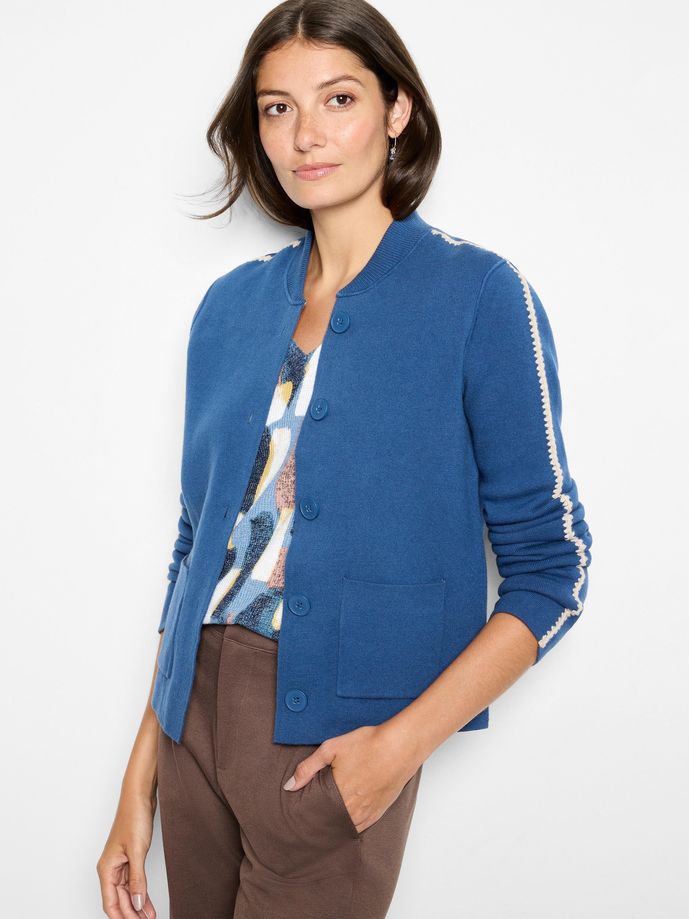 Deep blue knit bomber jacket featuring a ribbed collar, white zigzag trim on sleeves, and front patch pockets.