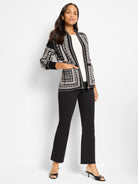 Black & white zip-front jacket with intricate Nordic geometric pattern. Features ribbed cuffs and side pockets.