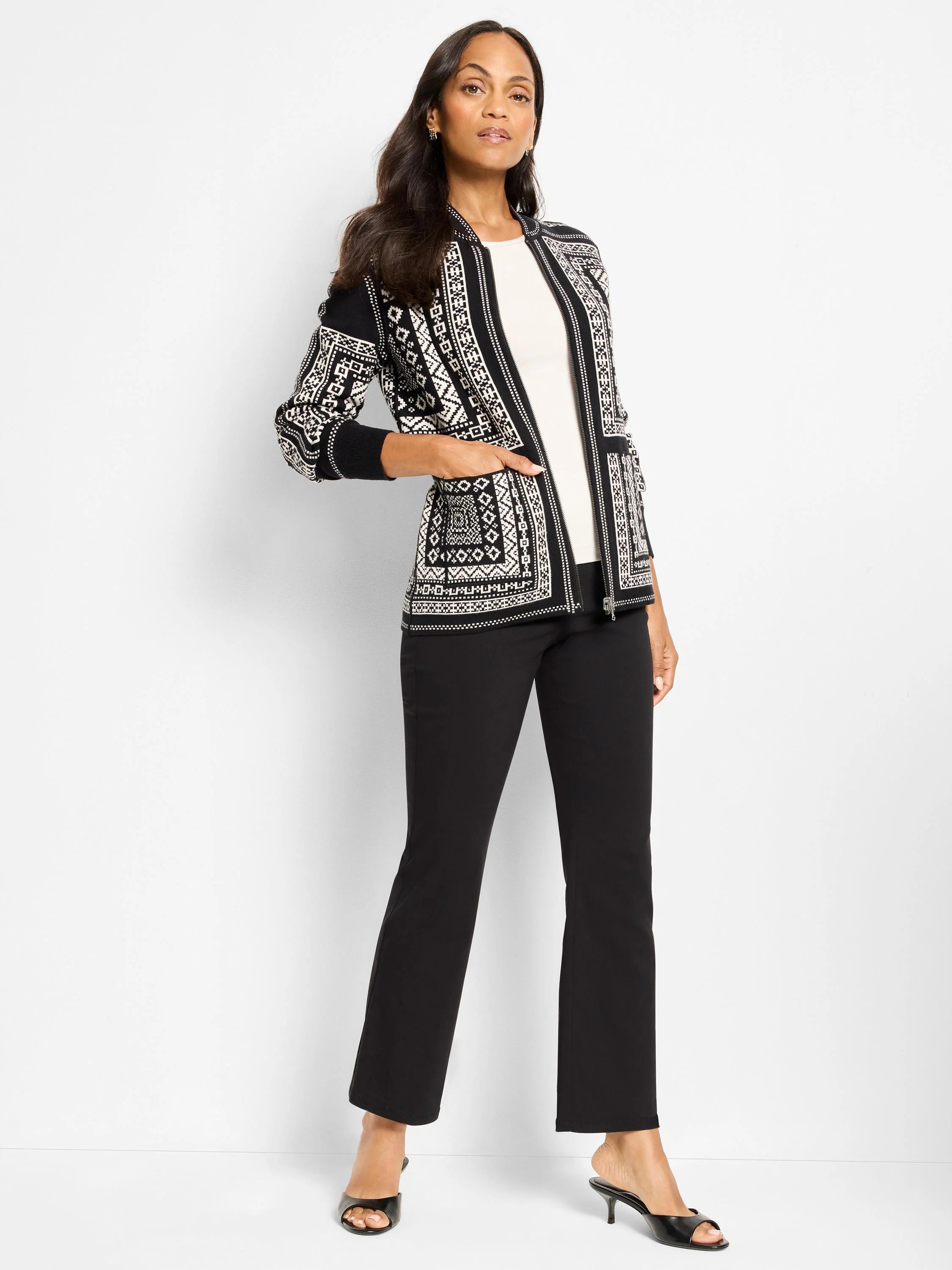 Black & white zip-front jacket with intricate Nordic geometric pattern. Features ribbed cuffs and side pockets.