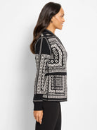 Black & white reversible jacket with intricate geometric Nordic pattern and solid cuffs.