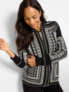 Black and white zip-up jacket with Nordic geometric patterns. Features ribbed cuffs and hem.