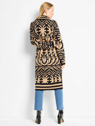 Black and tan long jacket with an abstract pattern, cinched at waist.
