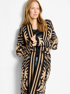 Black and tan knit long jacket with bold abstract zebra print and vertical stripes, cinched by a black tie belt.