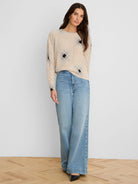 Light beige shaker stitch sweater with black and faded gray diamond print.